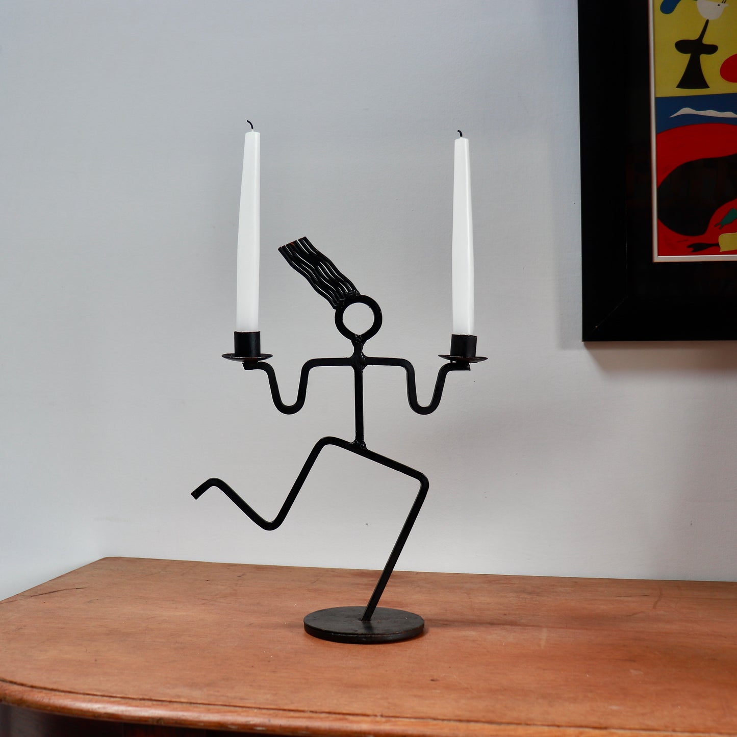Running figure iron candle holder on table