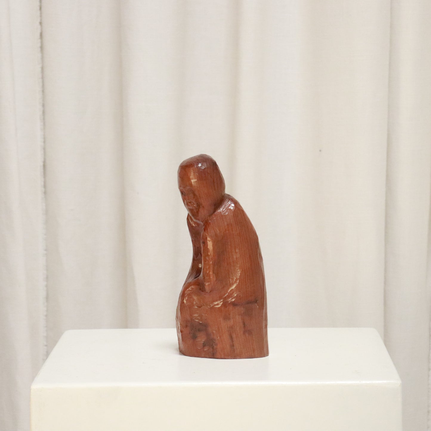 Side view of mid-century carved wood figure with polished finish
