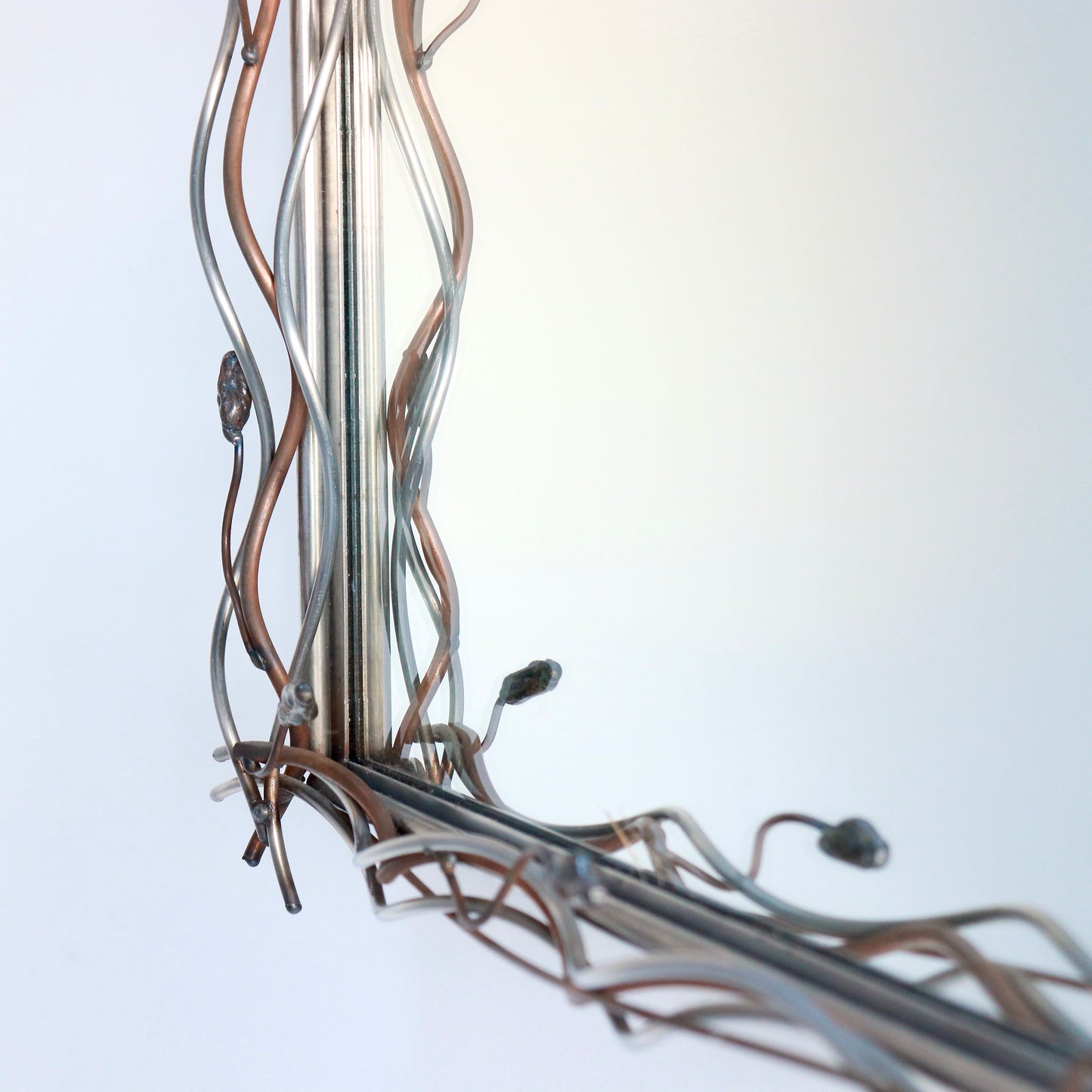 Sculptural metal mirror inspired by organic modernist design