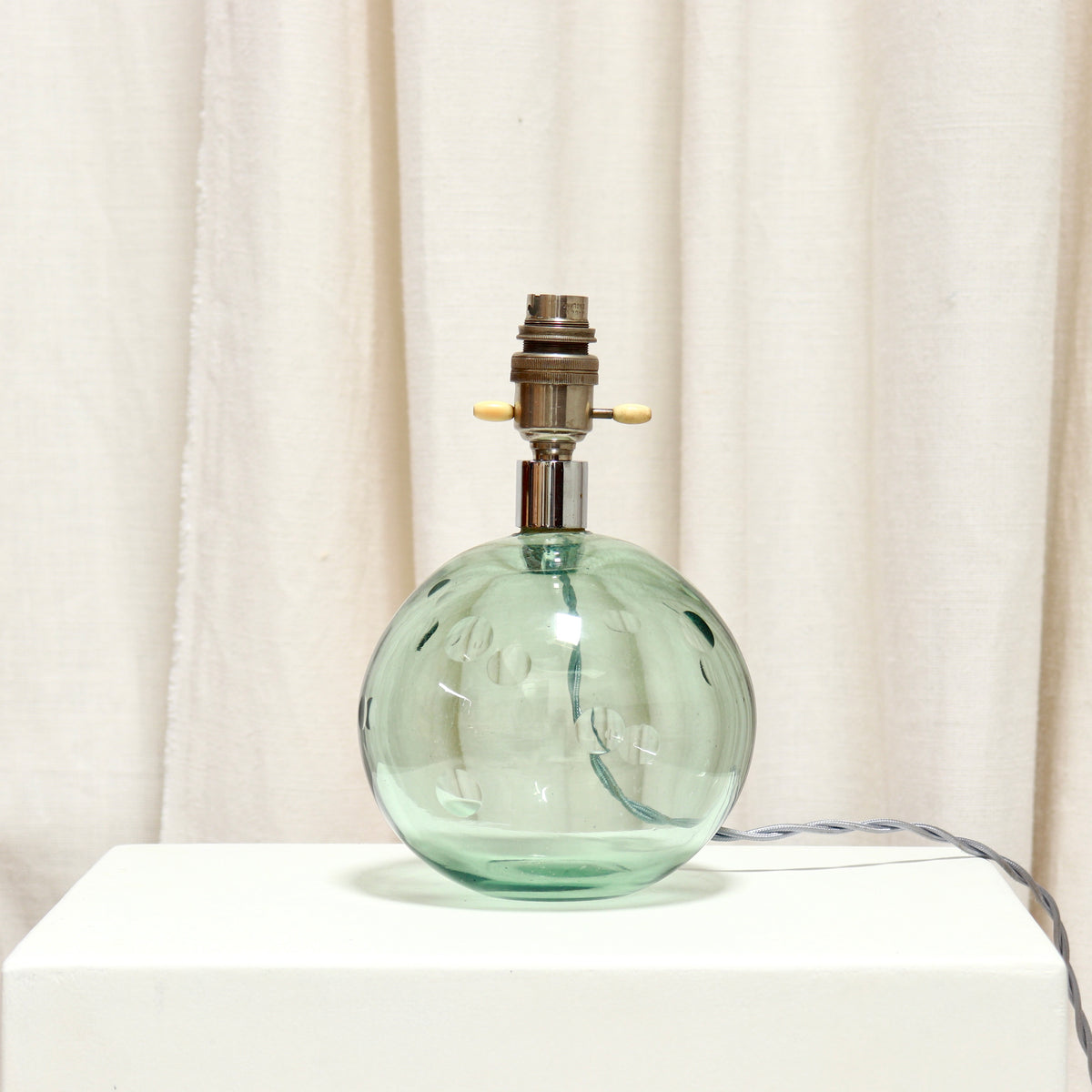 Vintage green glass ball lamp with hand cut dimple details
