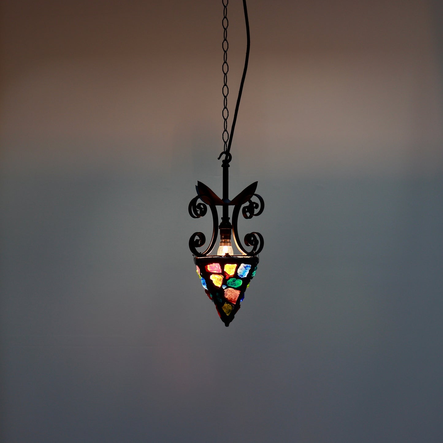 Brutalist lantern style pendant illuminated