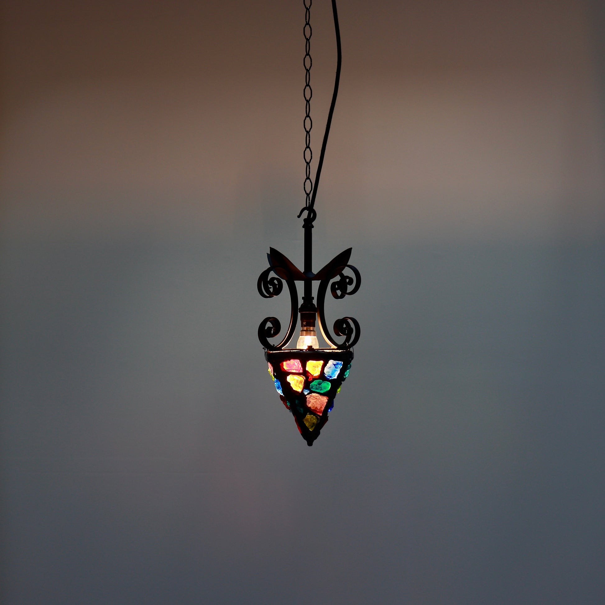 Brutalist lantern style pendant illuminated