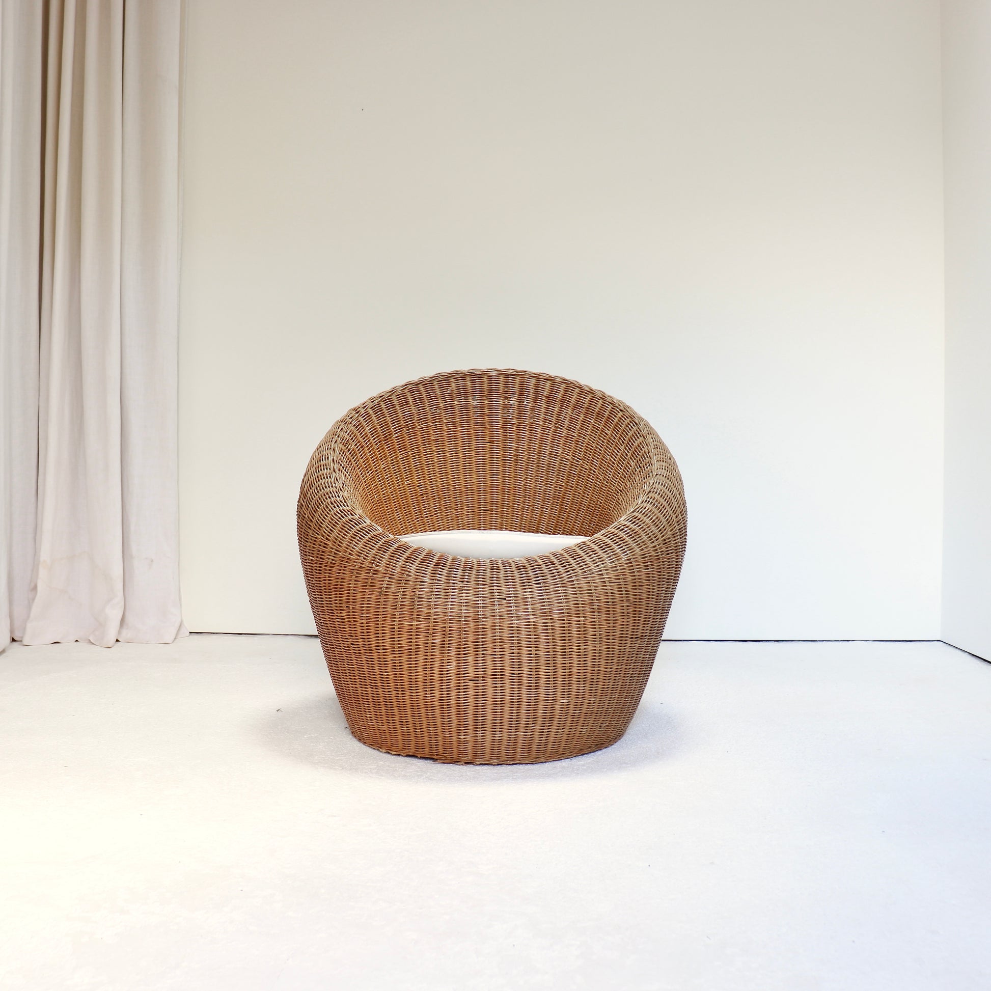 Vintage rattan lounge chair in the style of Isamu Kenmochi front view
