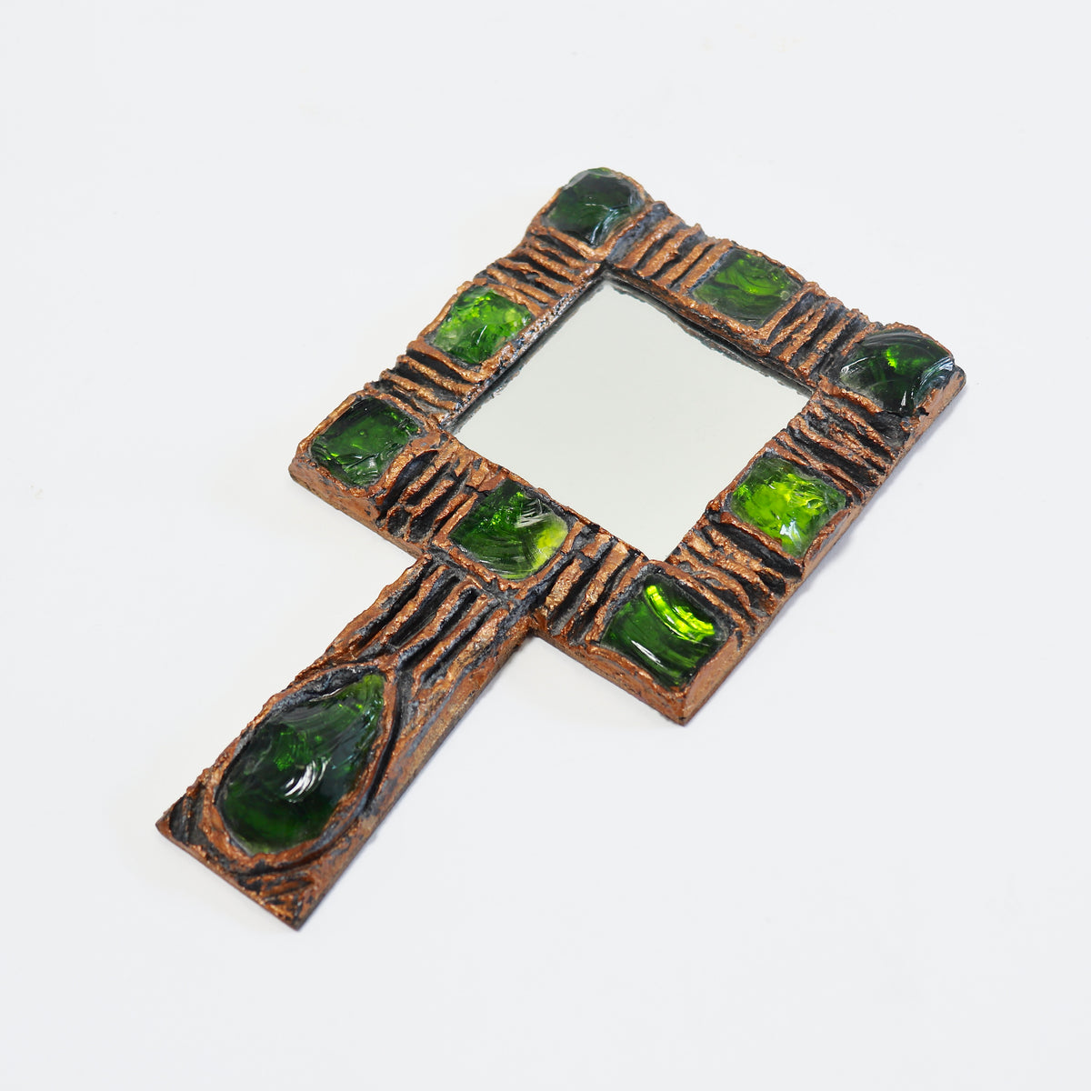 Angled view of vintage Gobesso hand mirror showing its square plate and handle