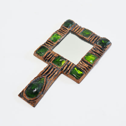 Angled view of vintage Gobesso hand mirror showing its square plate and handle