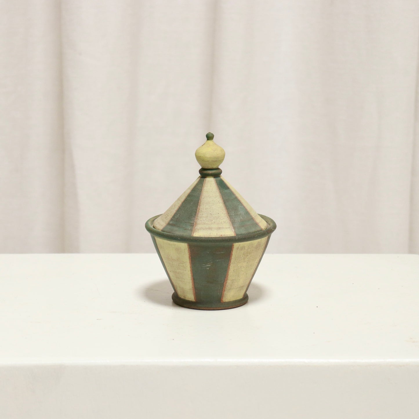 Small striped studio pottery lidded pot with conical lid and finial.