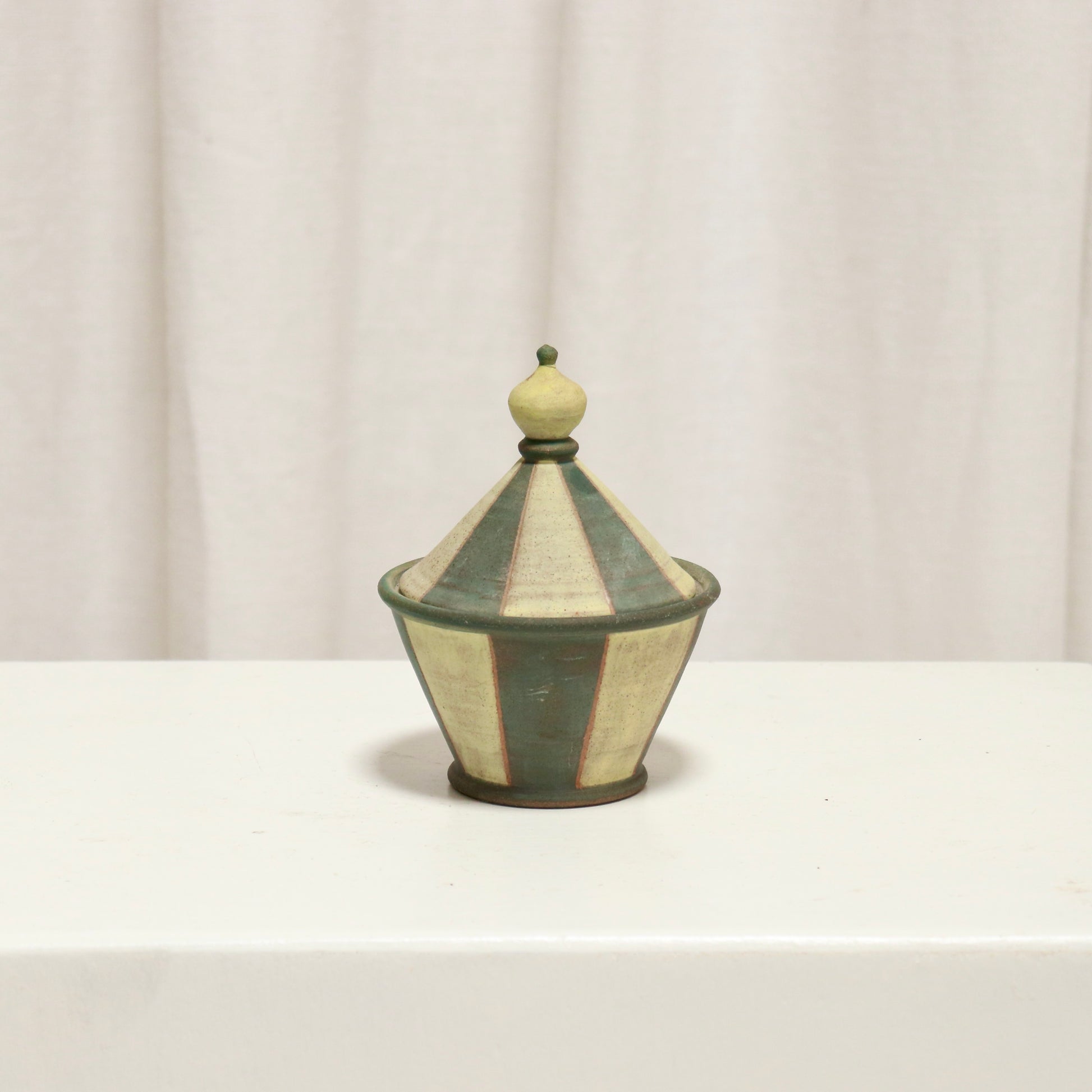 Small striped studio pottery lidded pot with conical lid and finial.