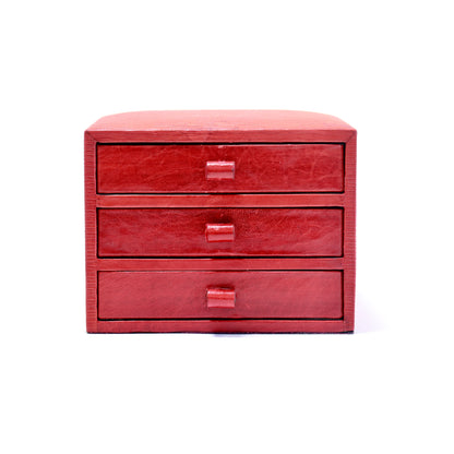 Red leather tabletop jewellery box with three drawers, front view