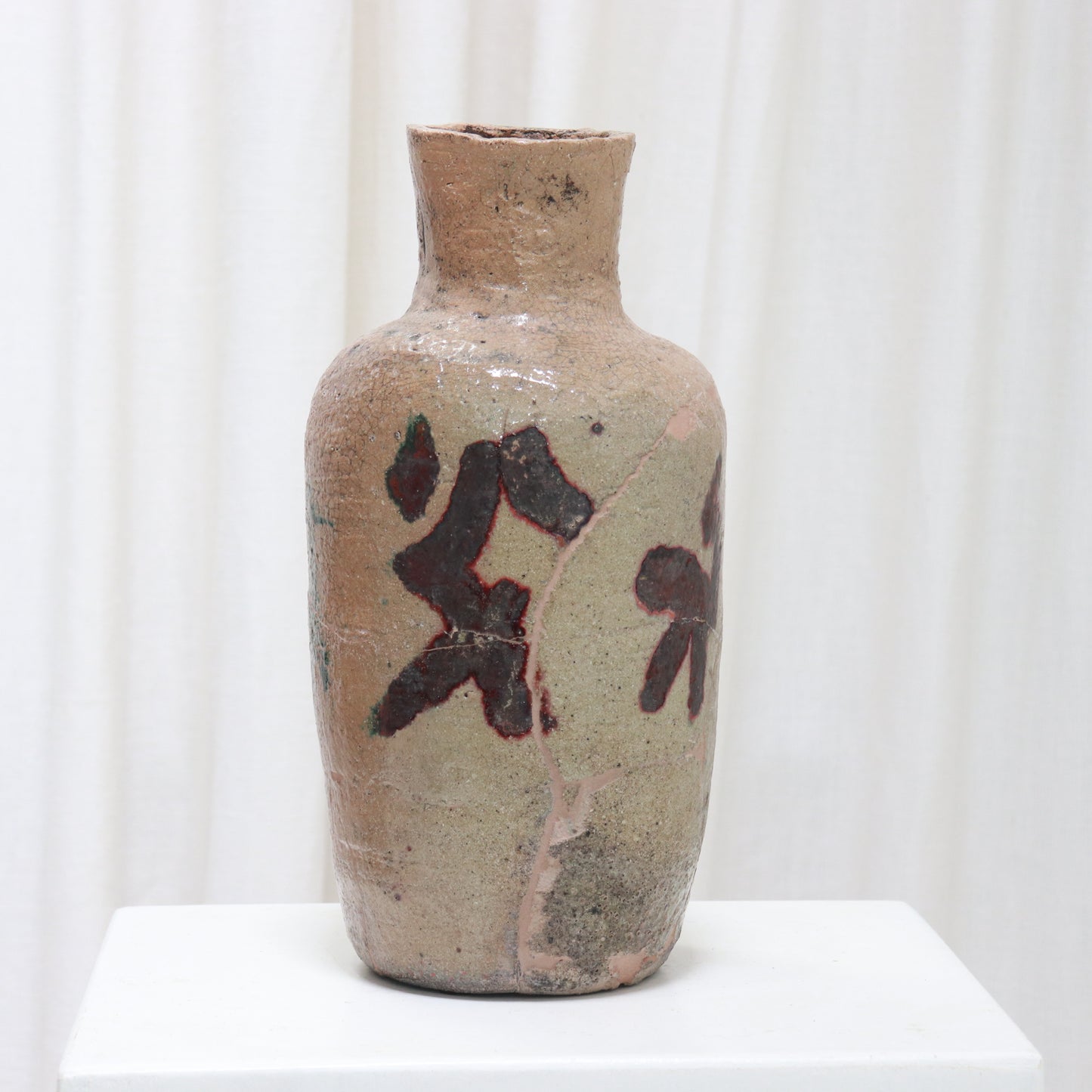 Textured stoneware vase with visible age and patina