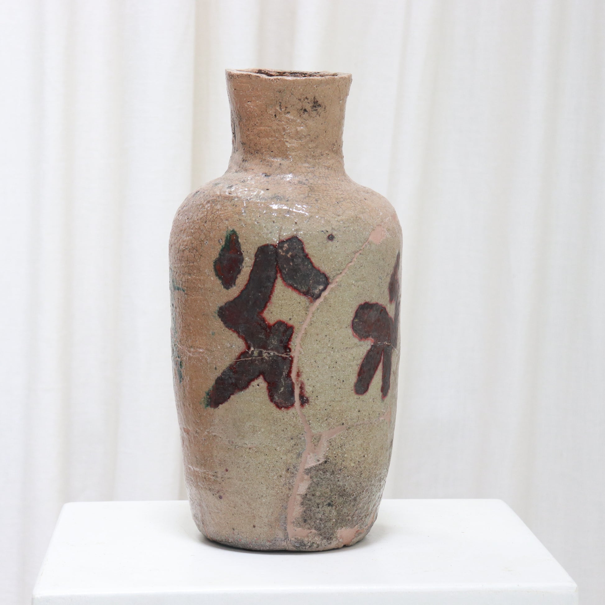 Textured stoneware vase with visible age and patina