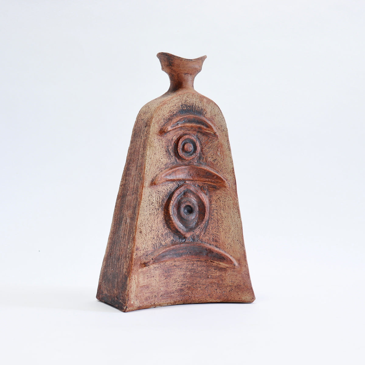 Mid-century Cornish pottery vessel with a tapered body, flared neck and raised abstract decoration in earthy brown and ochre tones.