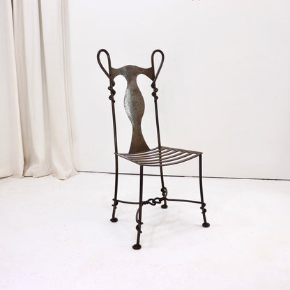 Hand-forged wrought iron chair with sculptural backrest