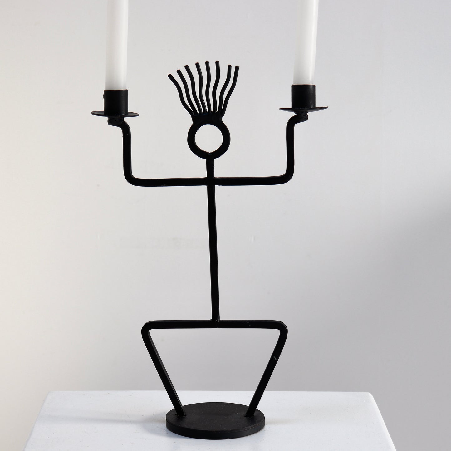 Vintage figural iron candelabra styled on plinth