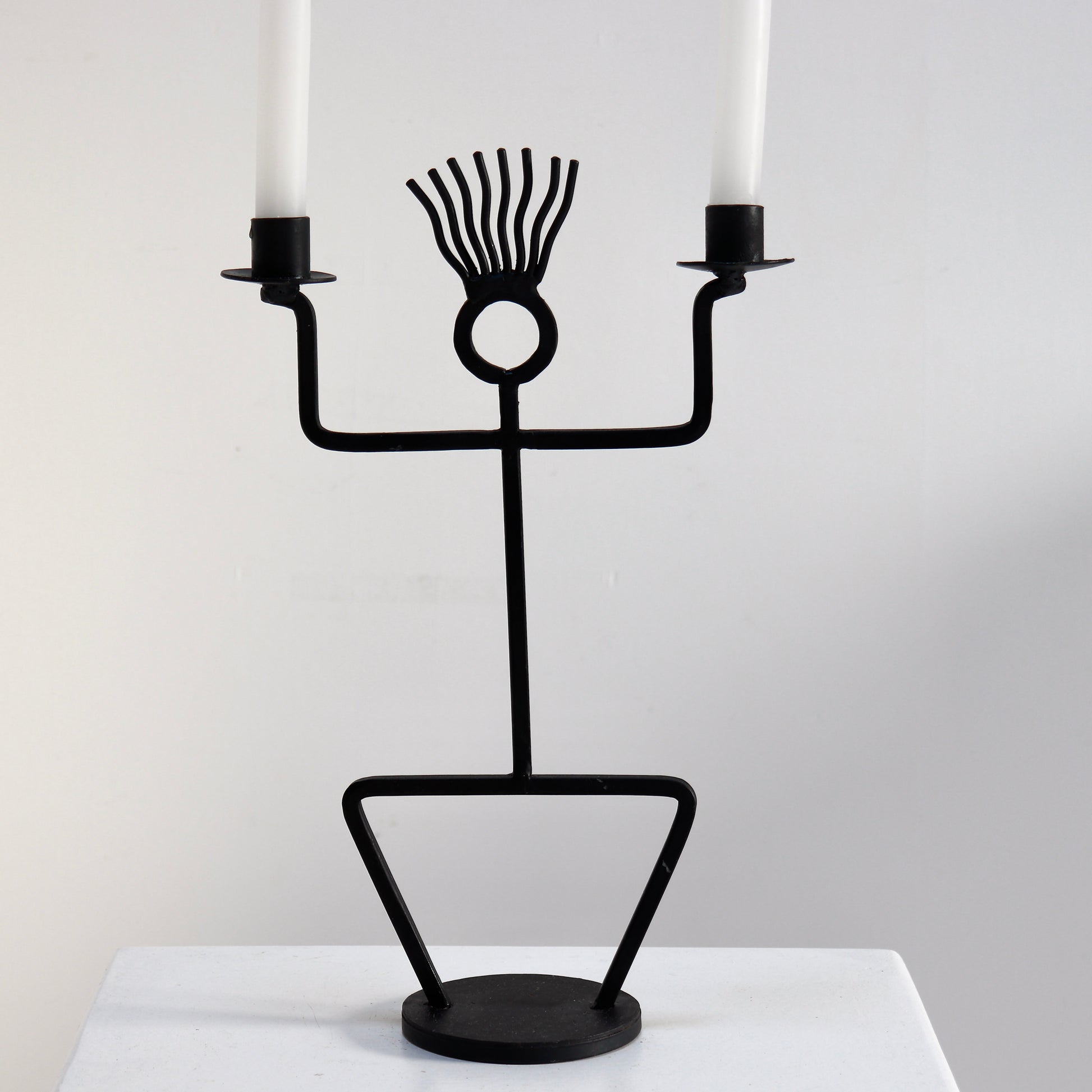 Vintage figural iron candelabra styled on plinth