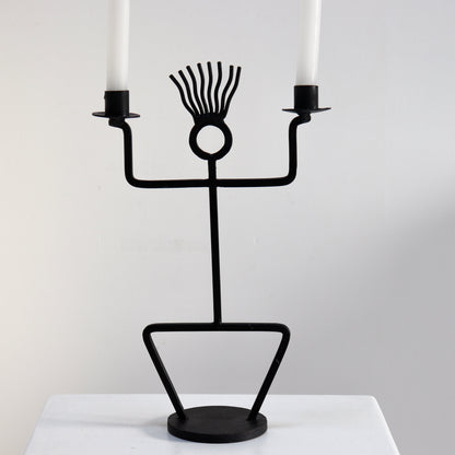 Vintage figural iron candelabra styled on plinth