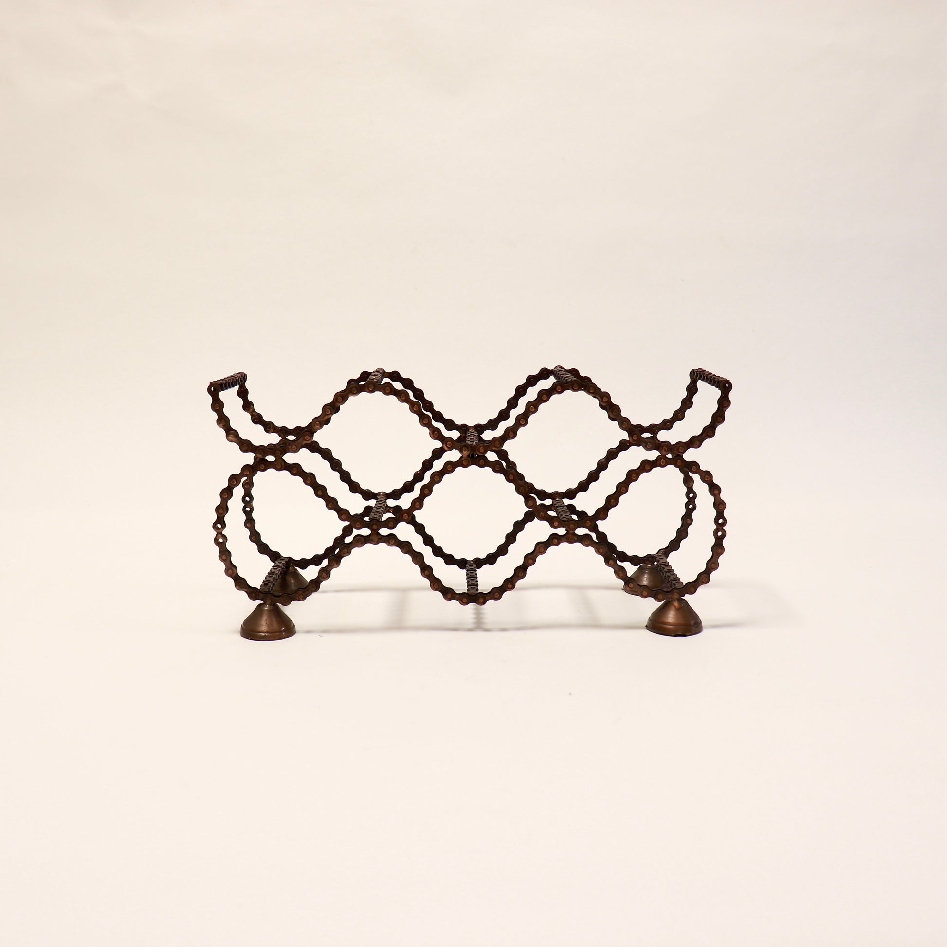 Vintage folk art bicycle chain wine rack with industrial character