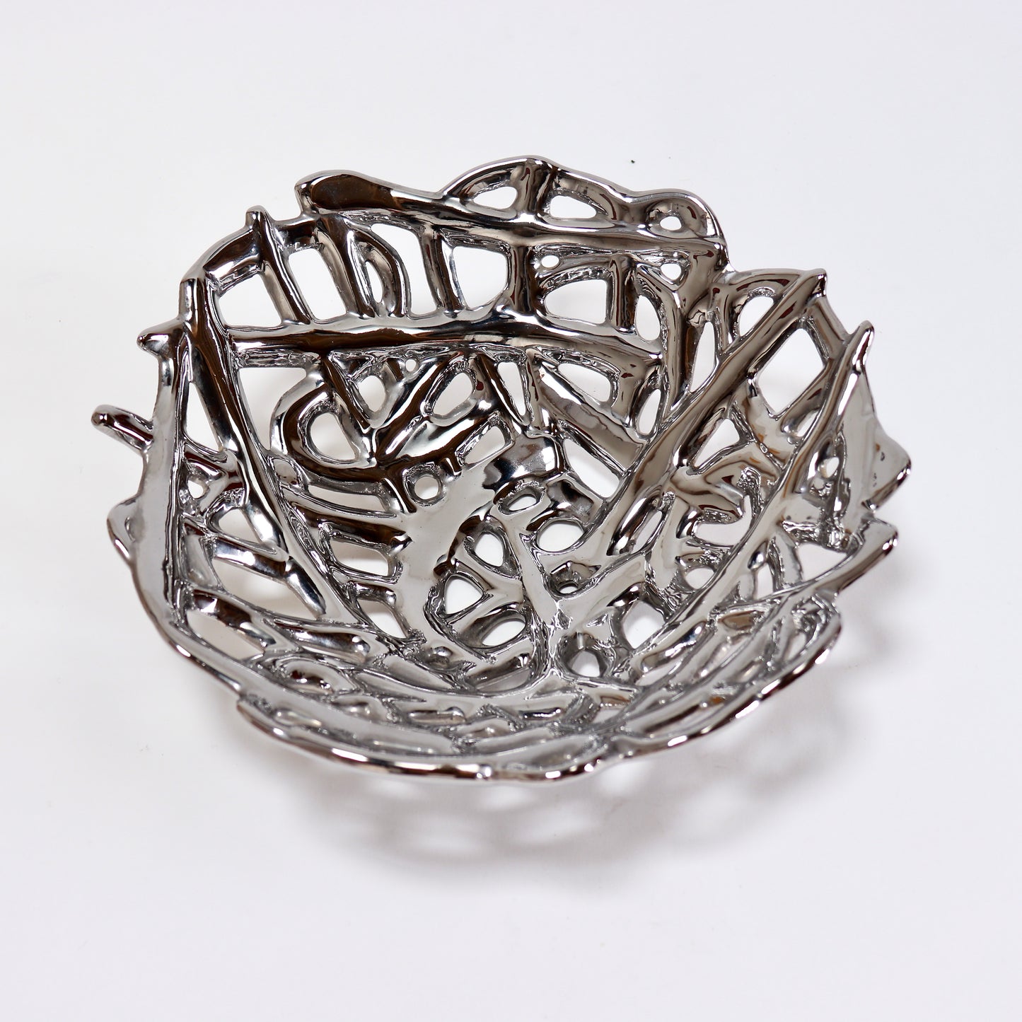 Reflective silver ceramic fruit bowl with organic branch-like structure