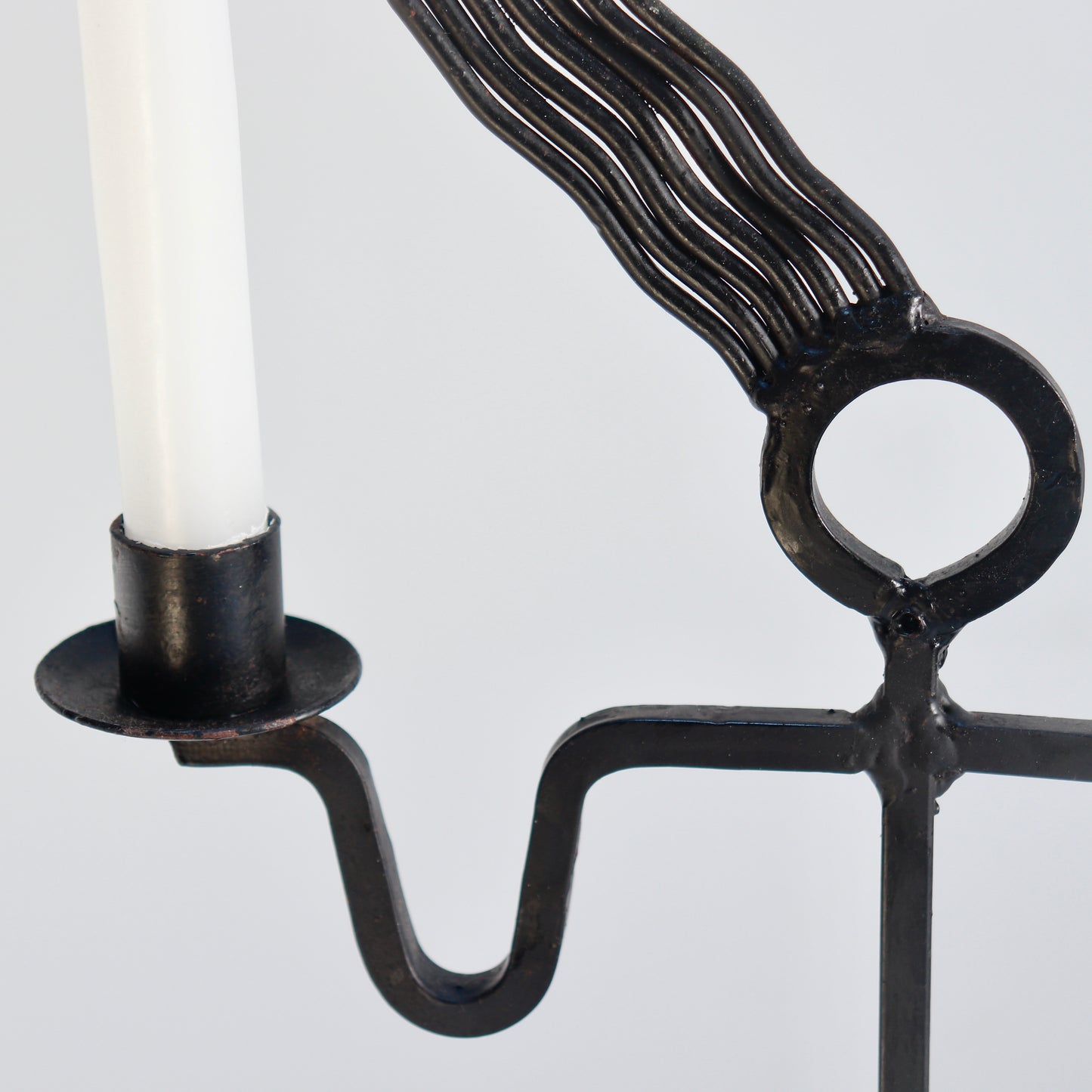 Blackened iron figural candle holder detail