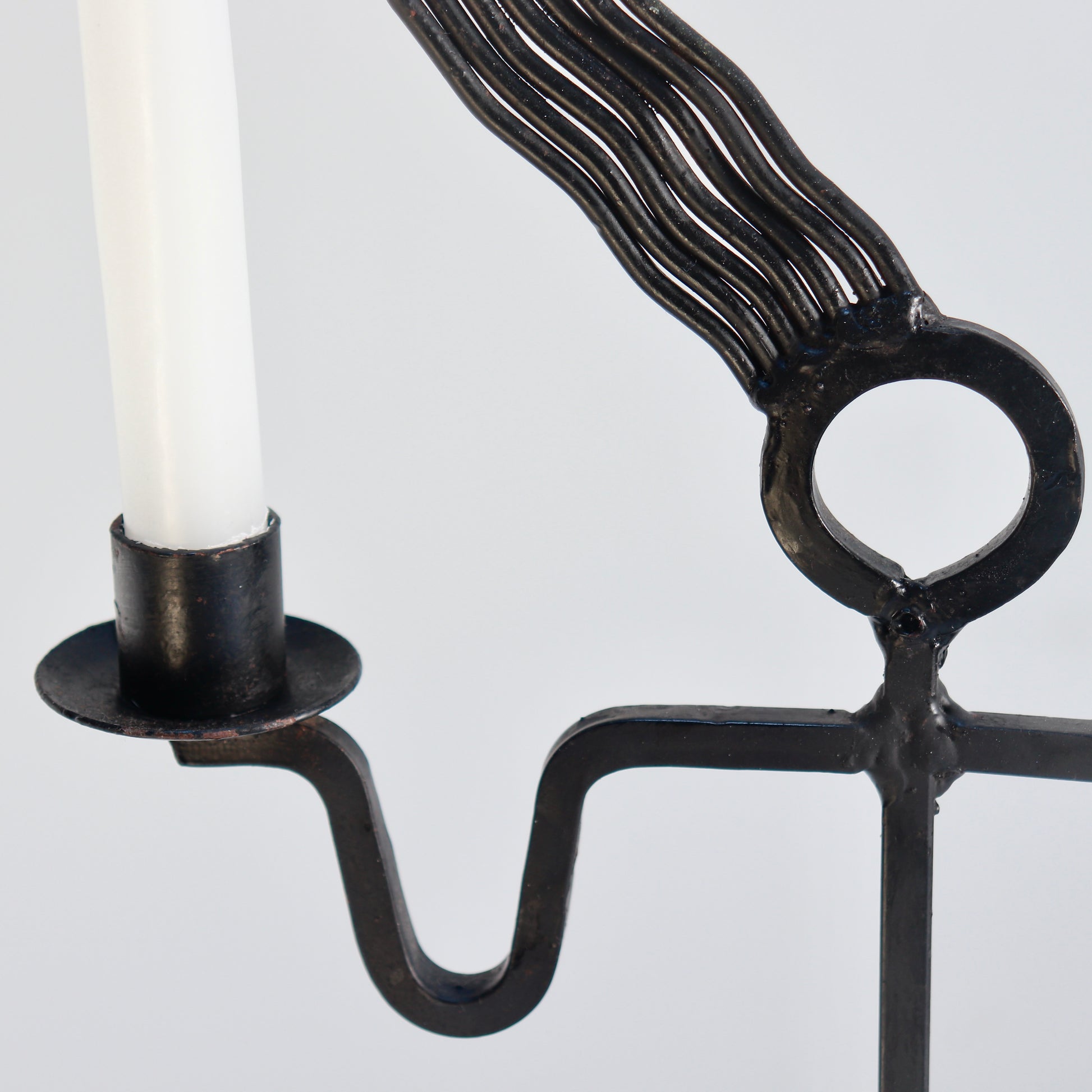 Blackened iron figural candle holder detail