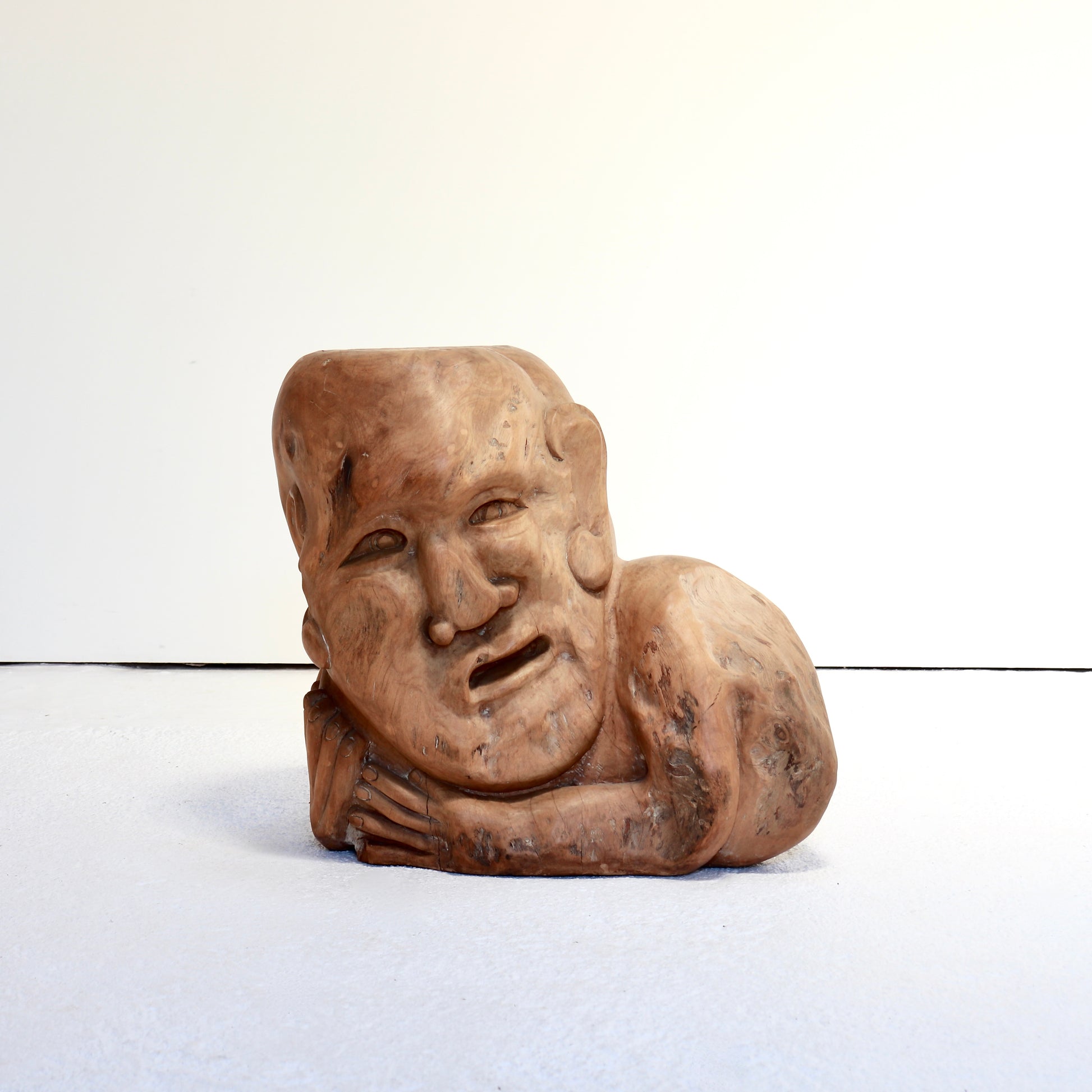 Vintage carved wooden side table with expressive face