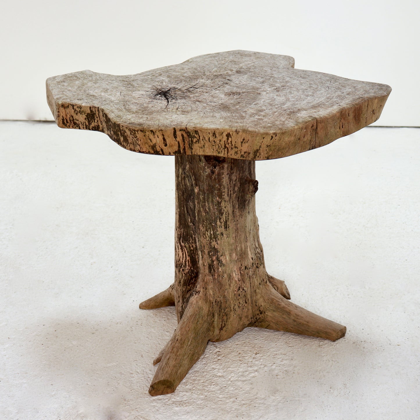 Primitive hand-carved hardwood side table with sculptural tree root base.