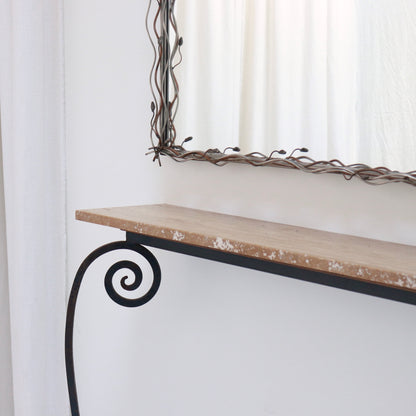 Close-up of scroll-leg detailing on iron console