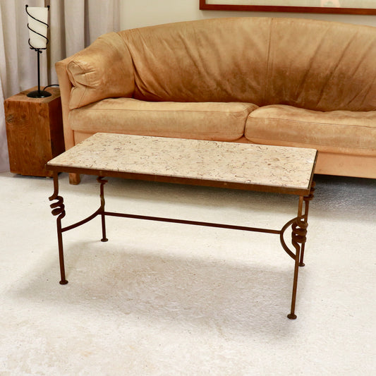 “Fossilised stone and wrought-iron coffee table, front view”