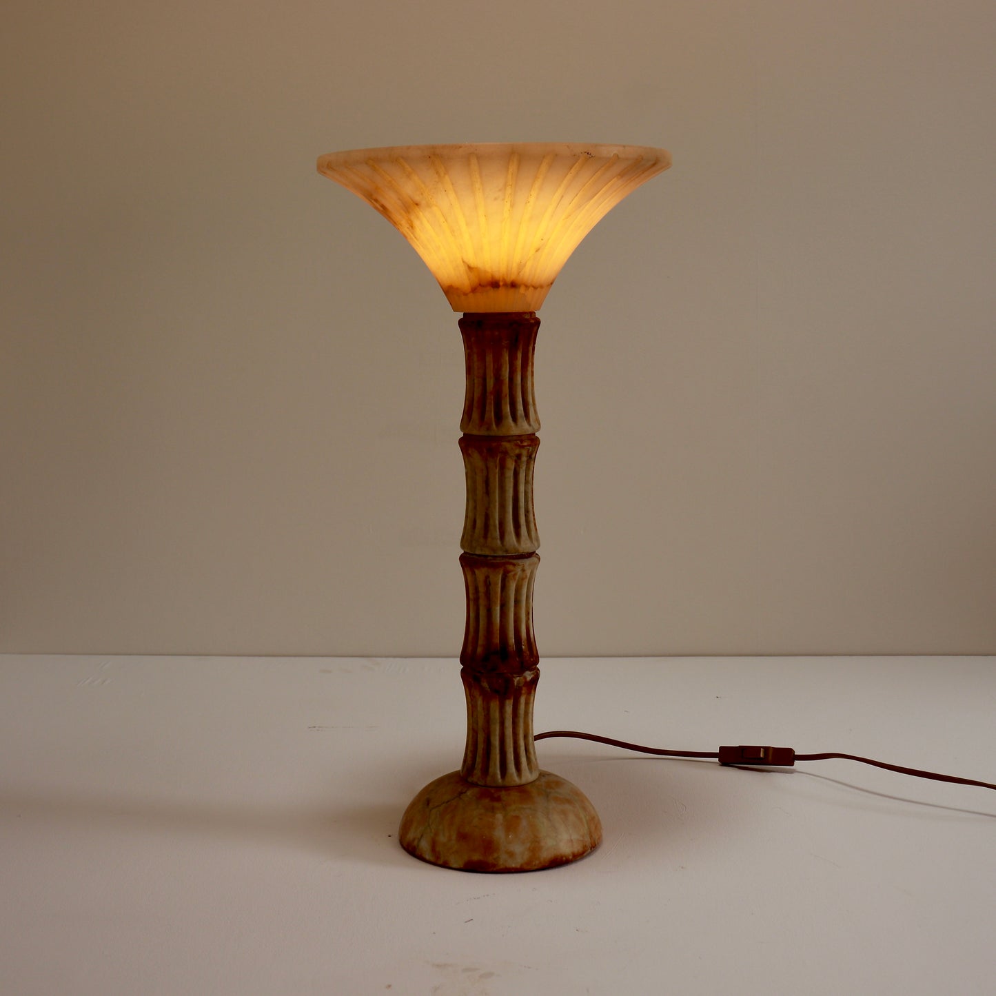 Illuminated alabaster uplighter showing natural veining.