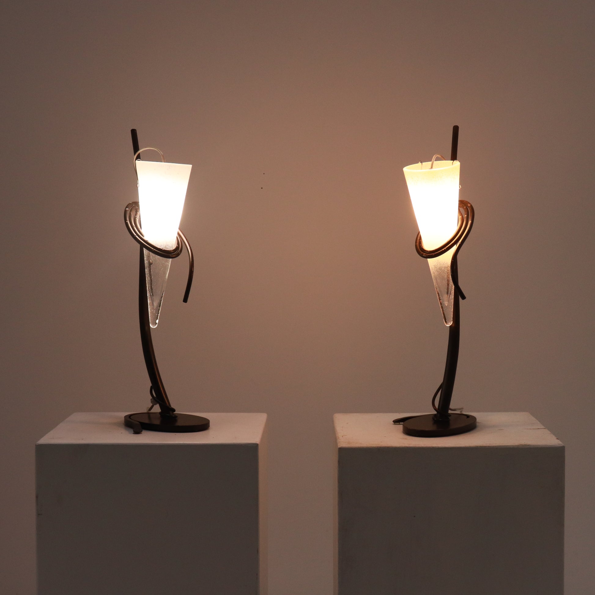 Lamps illuminated, warm ambient light through frosted cones.