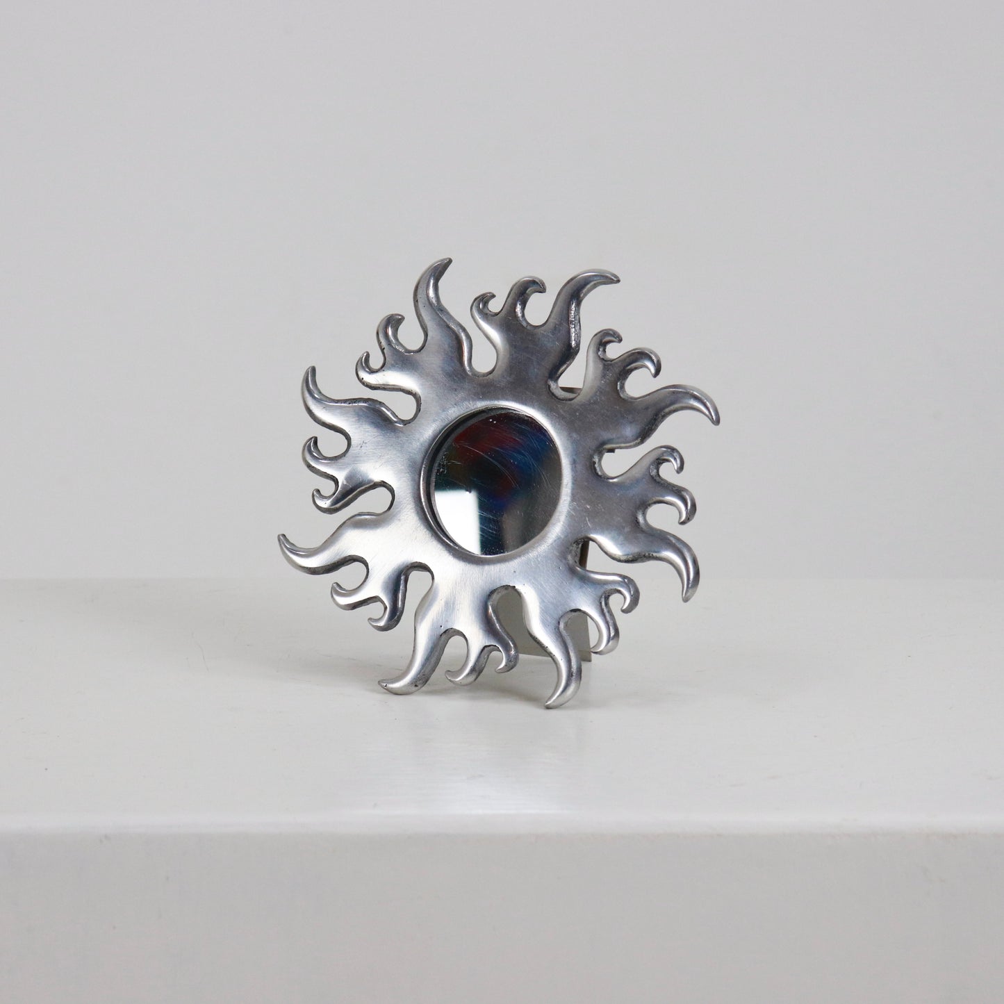 Petite cast aluminium sunburst mirror with flame rays front view