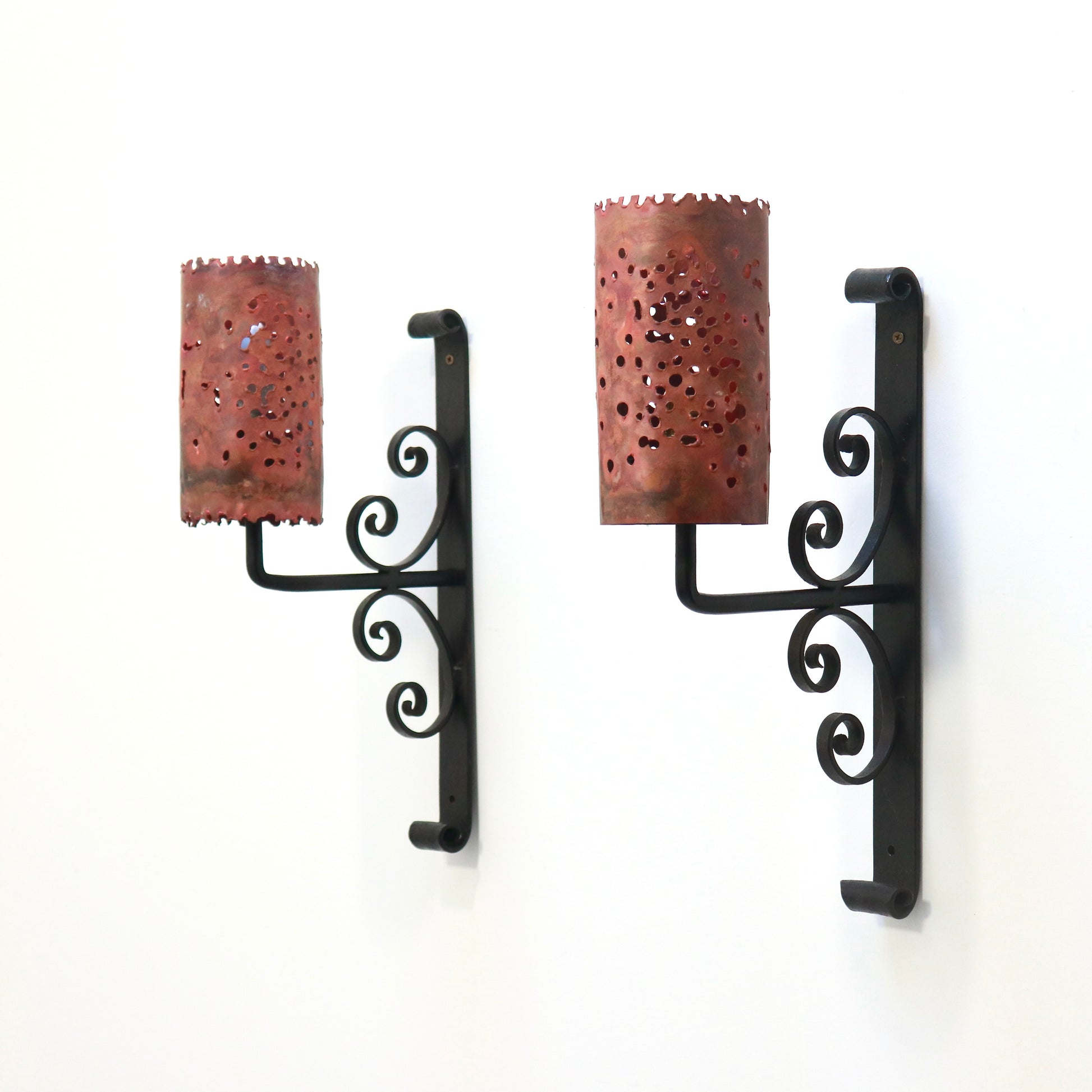 Pair of copper and wrought-iron wall lights with perforated cylindrical shades
