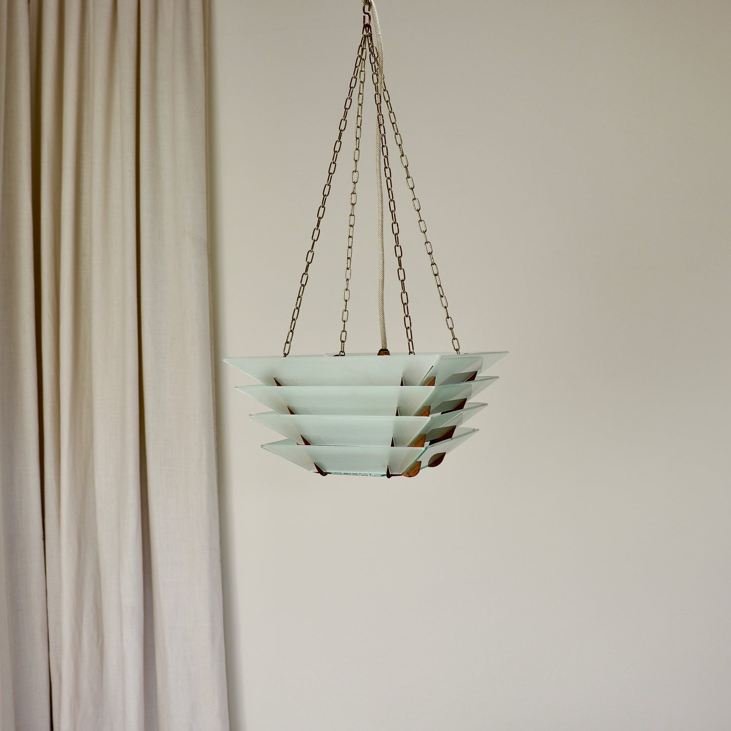 Tiered frosted glass ceiling light with brass chain