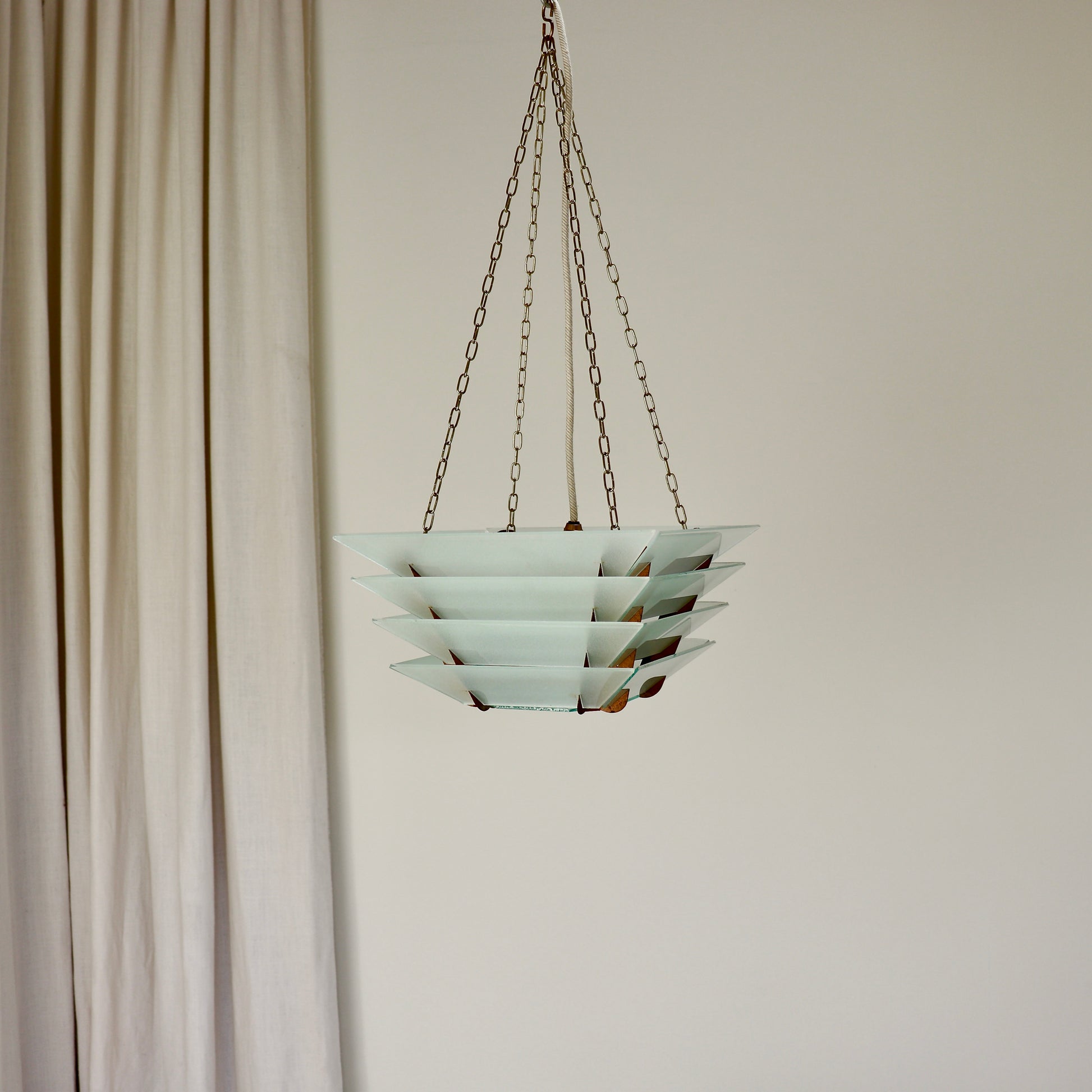Tiered frosted glass ceiling light with brass chain