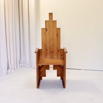 Front view of stepped-back pine throne chair attributed to Renzo Baldanello.