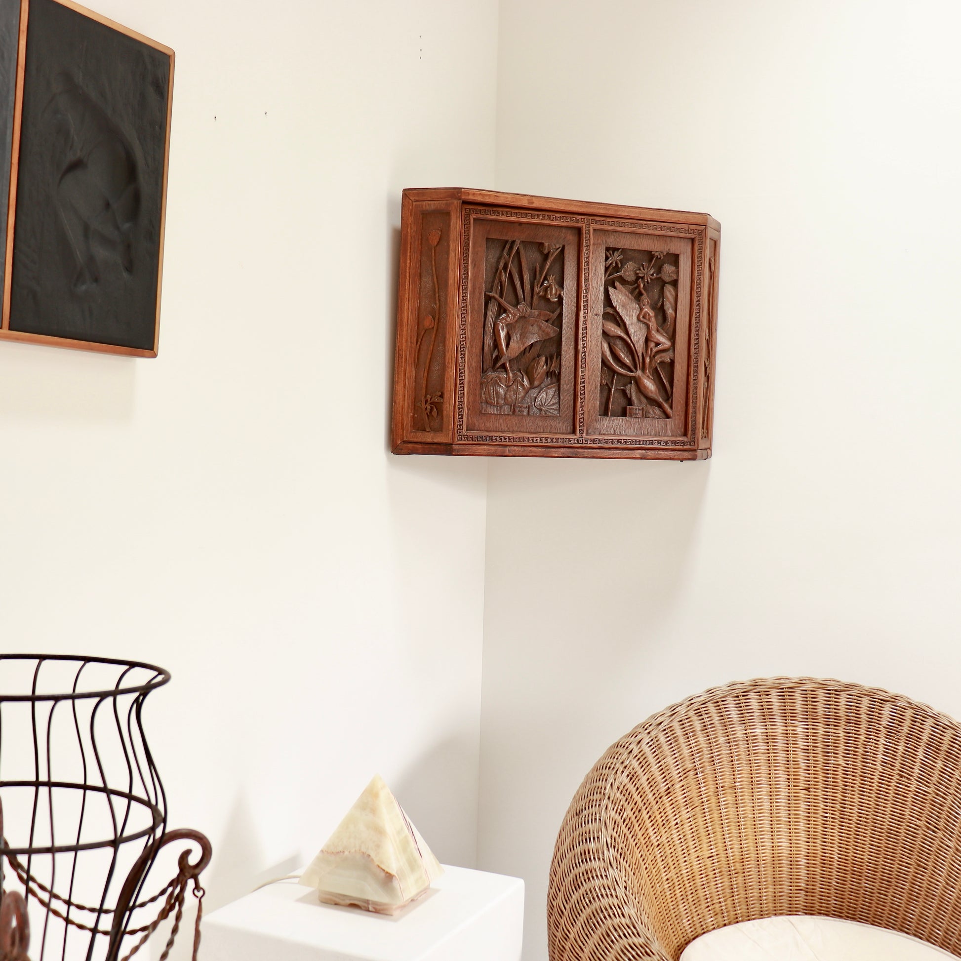 Sculptural folk art cupboard in corner interior setting