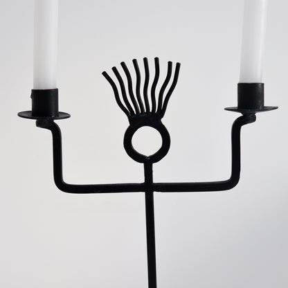 Graphic sculptural candle holder in blackened iron