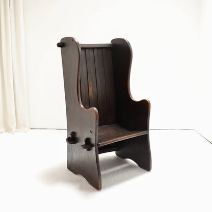 Side profile of sculptural wooden lambing chair