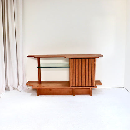 Oak and glass console sideboard in minimalist interior setting