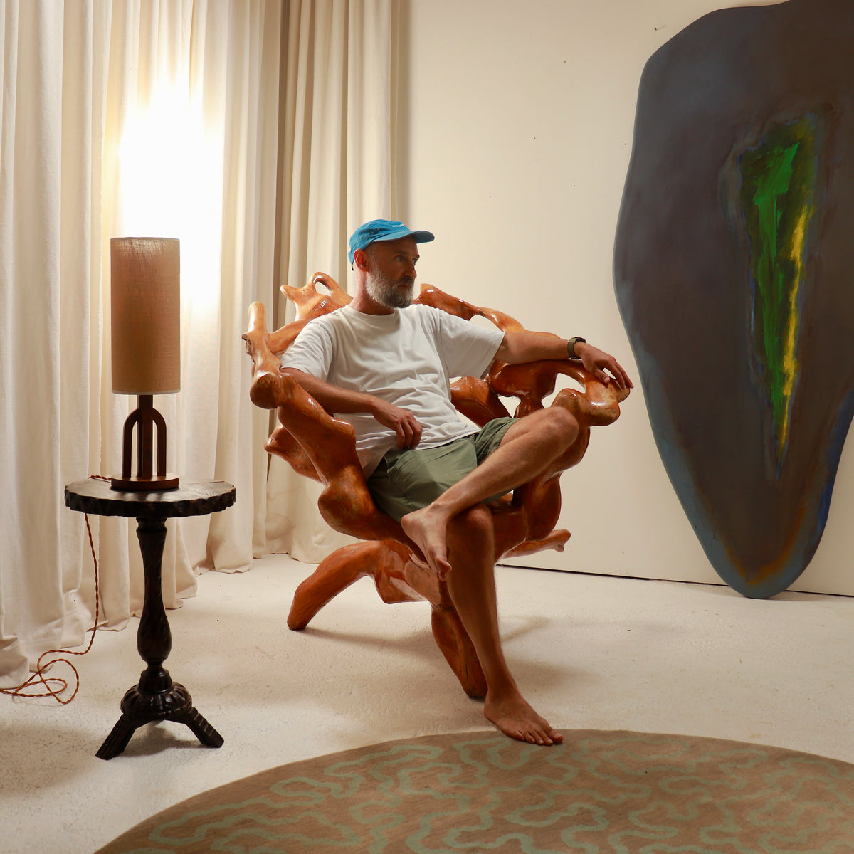 Large sculptural root wood armchair shown in an interior setting
