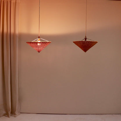 Rattan uplighter pendant light shown illuminated with warm glow
