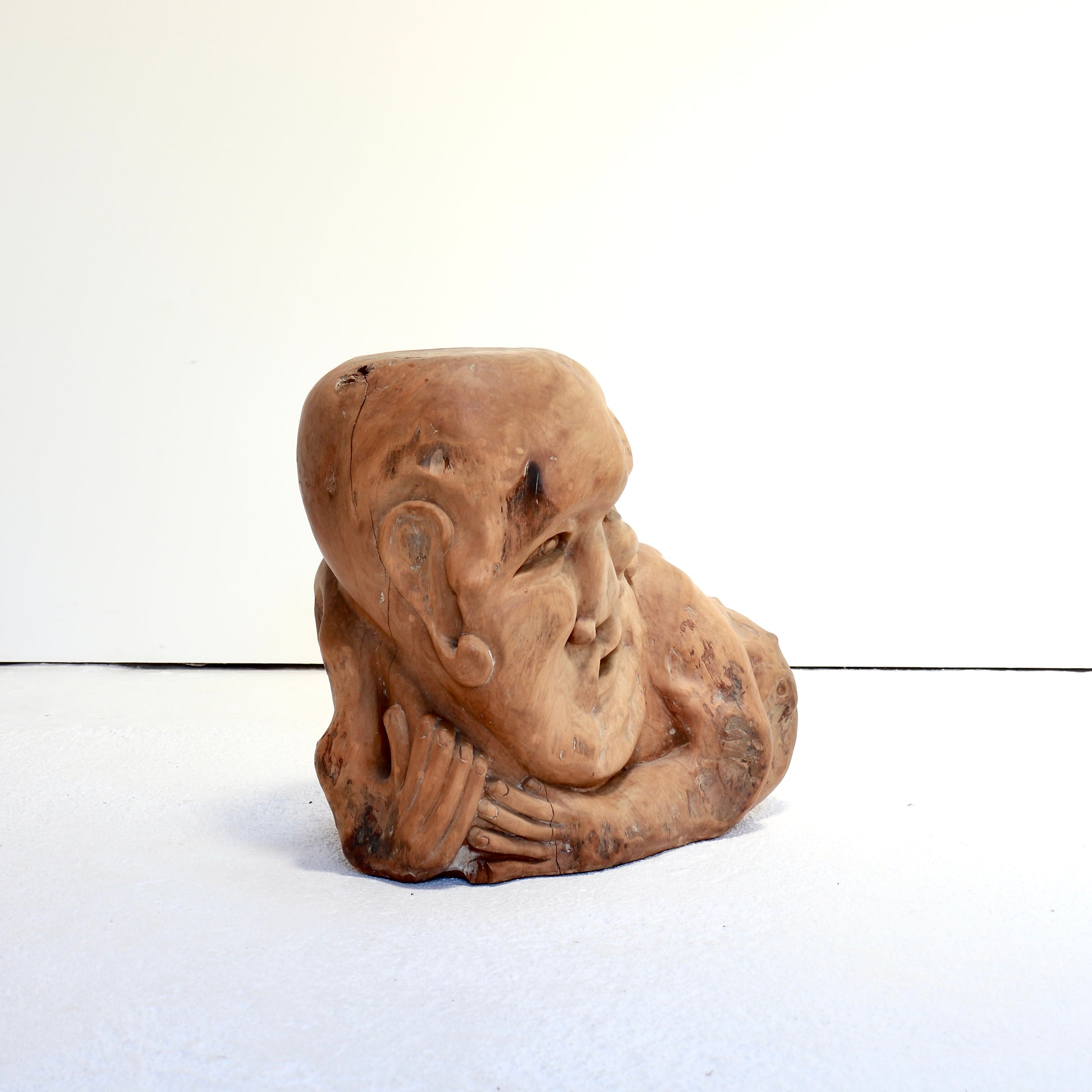 Hand-carved reclining figure used as an occasional table