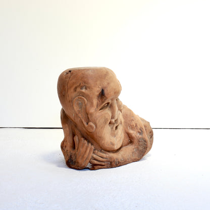 Hand-carved reclining figure used as an occasional table