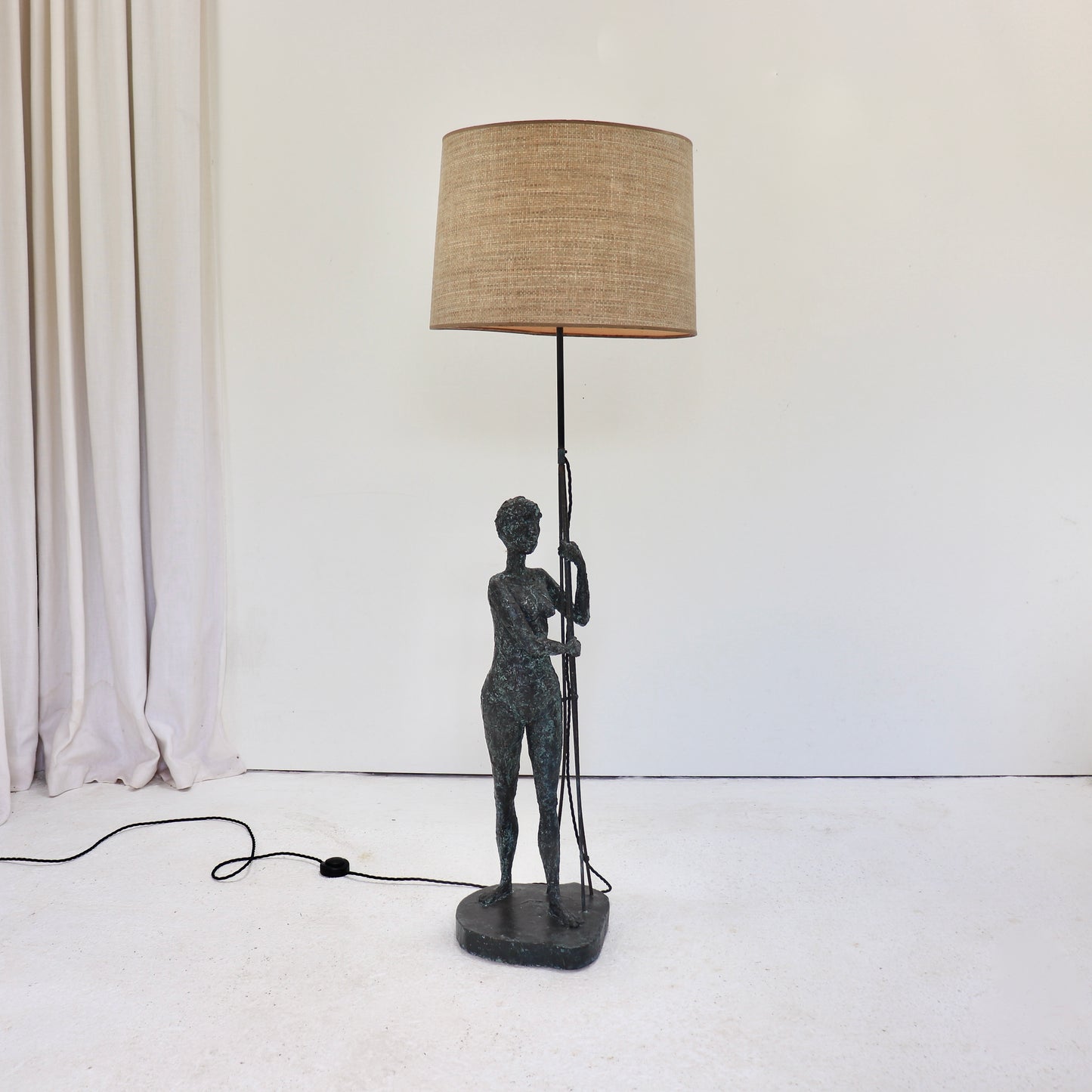 Sculptural female figure floor lamp with patinated finish