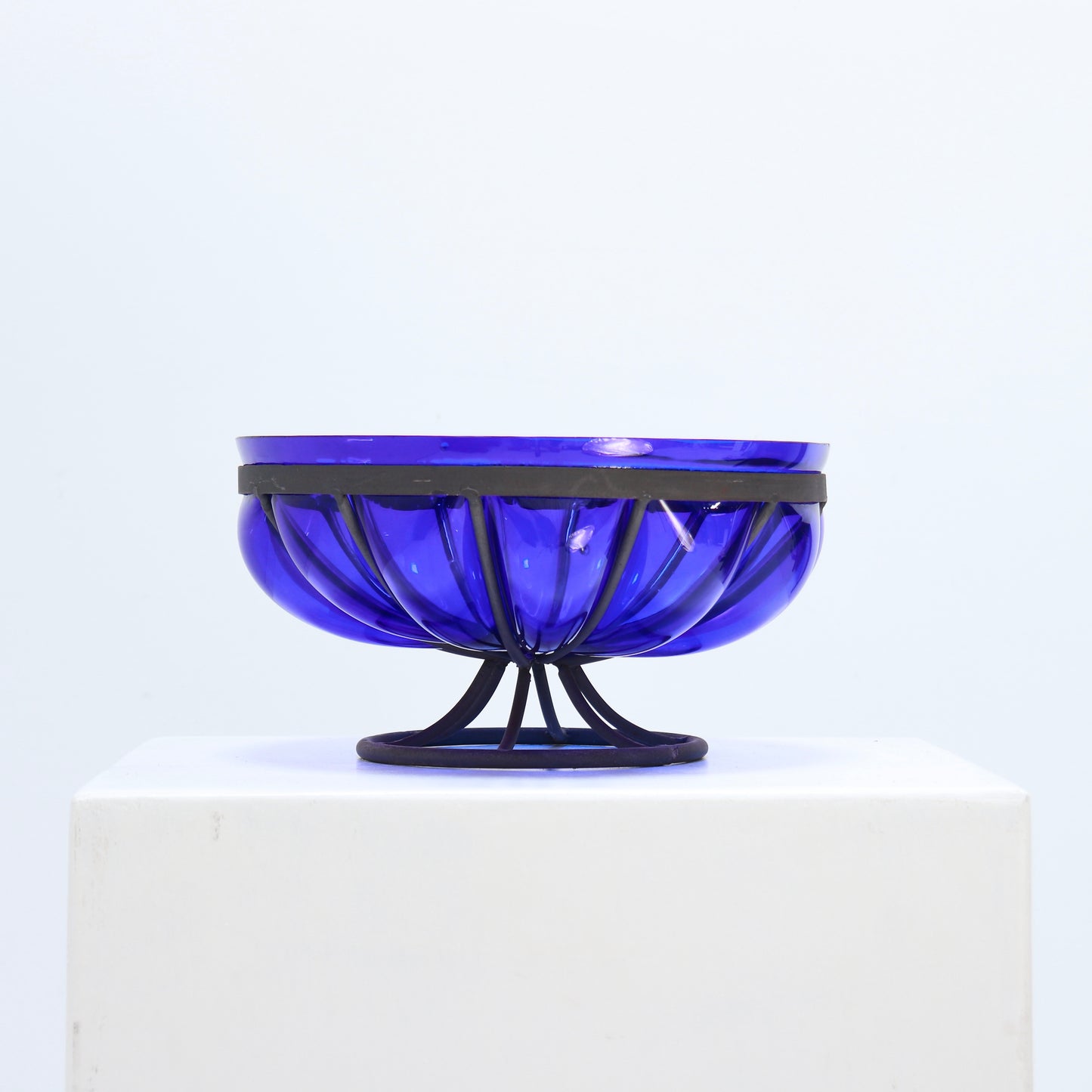 Cobalt blue glass bowl in ribbed metal stand