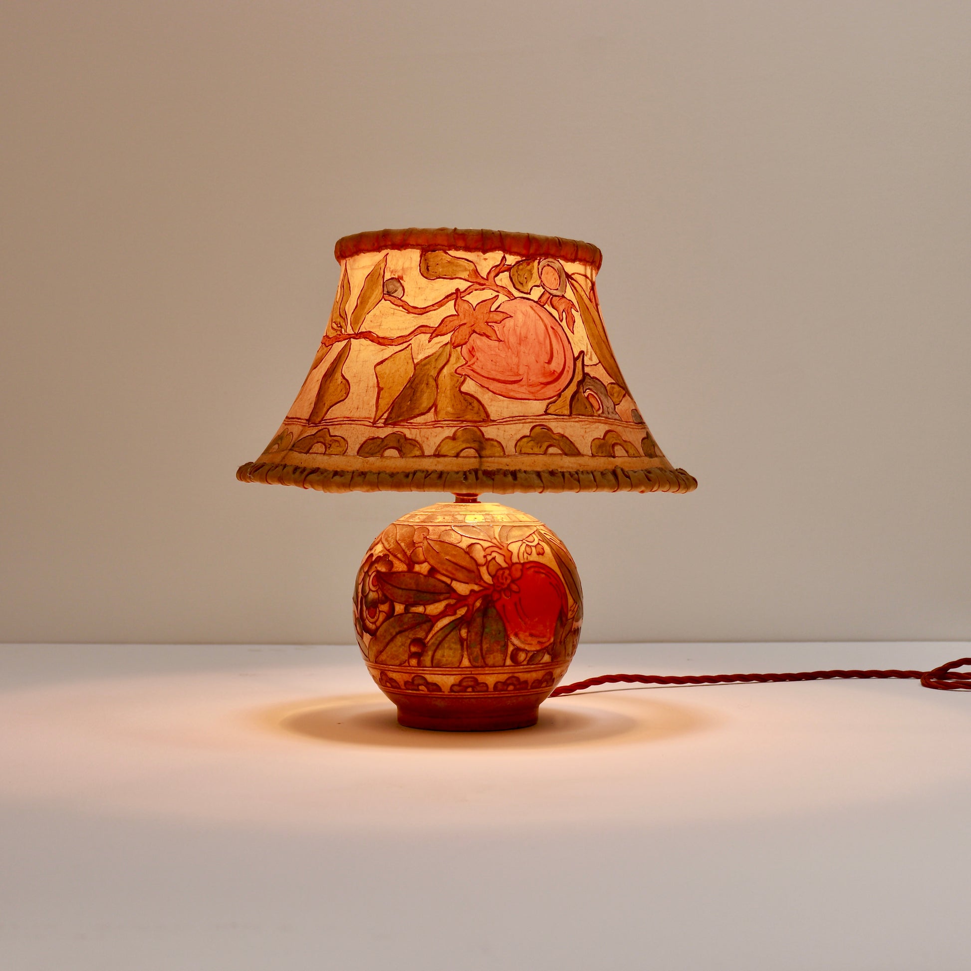 Vintage Bursley Ware lamp glowing lit
