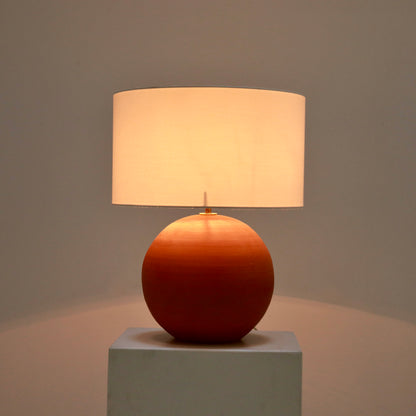 Terracotta lamp lit with soft warm glow