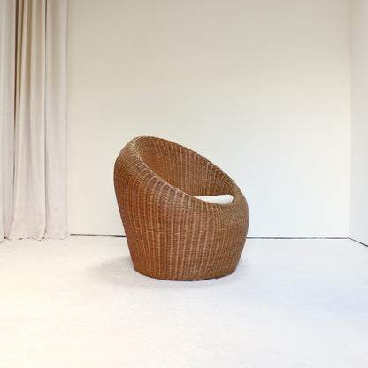 Sculptural woven rattan tub chair with rounded form