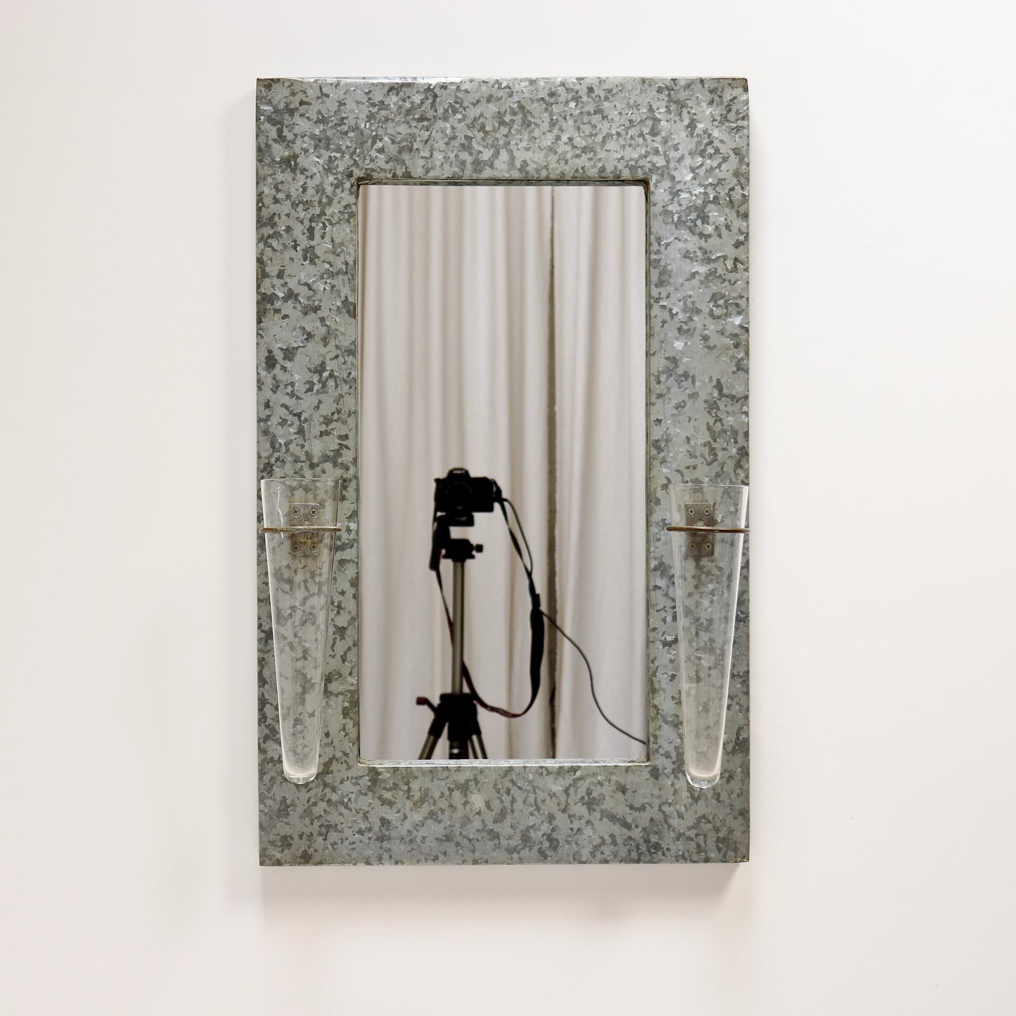 Industrial galvanised mirror with floral tube vases
