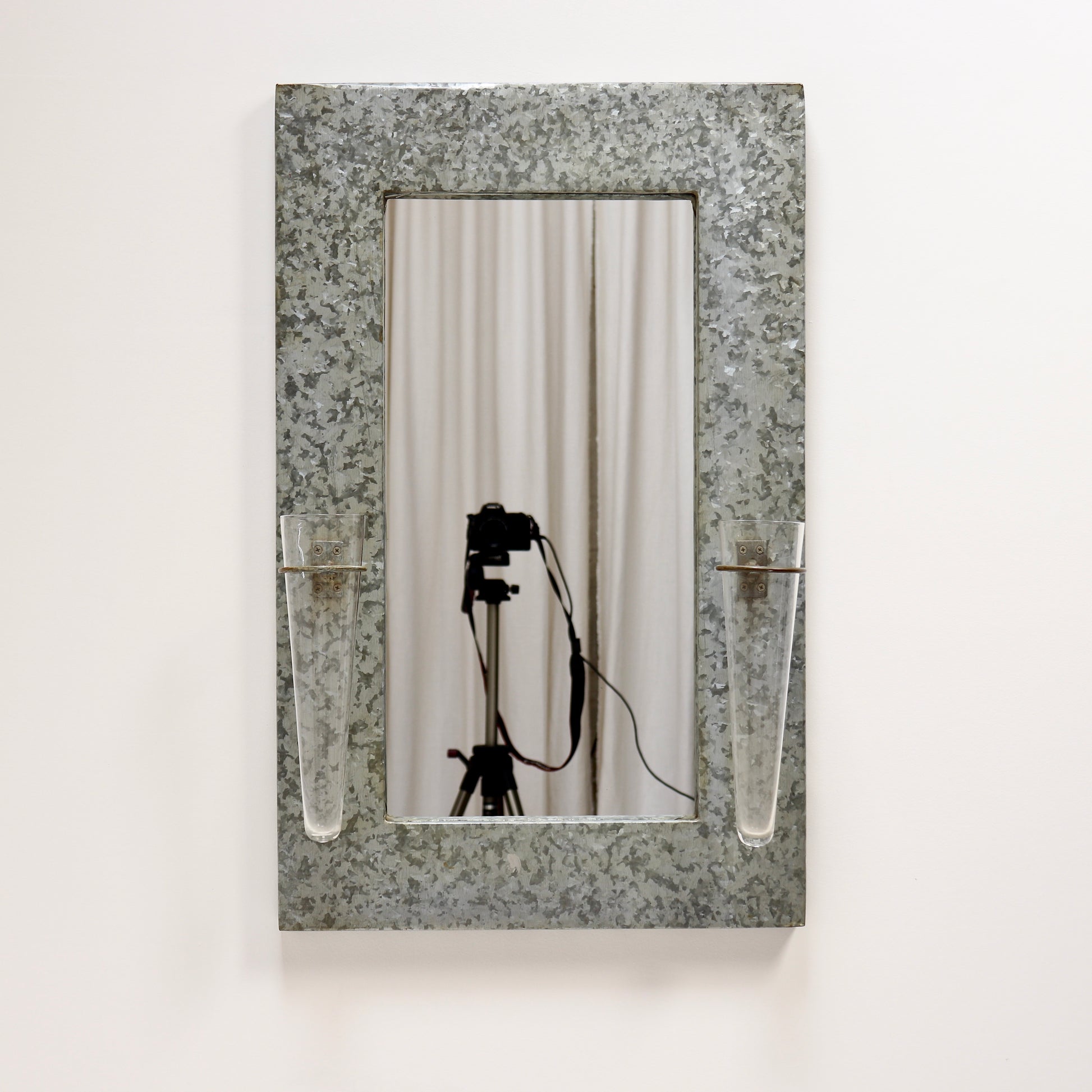 Industrial galvanised mirror with floral tube vases
