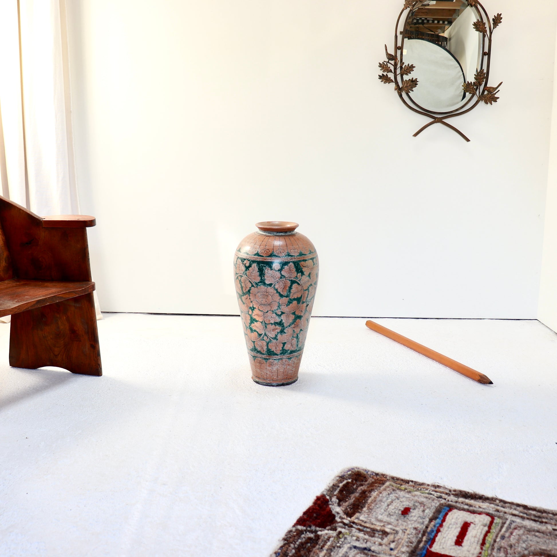 Hand painted terracotta vase with scrolling floral decoration